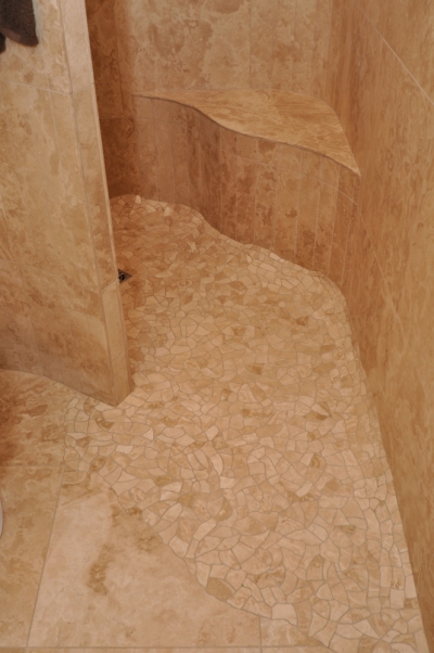 Shower floor of travertine stone, each piece hand cut with nippers and edge sanded