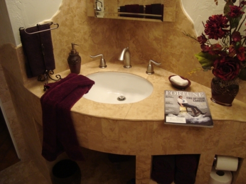 Elliptical stone covered vanity made from Kerdi-board